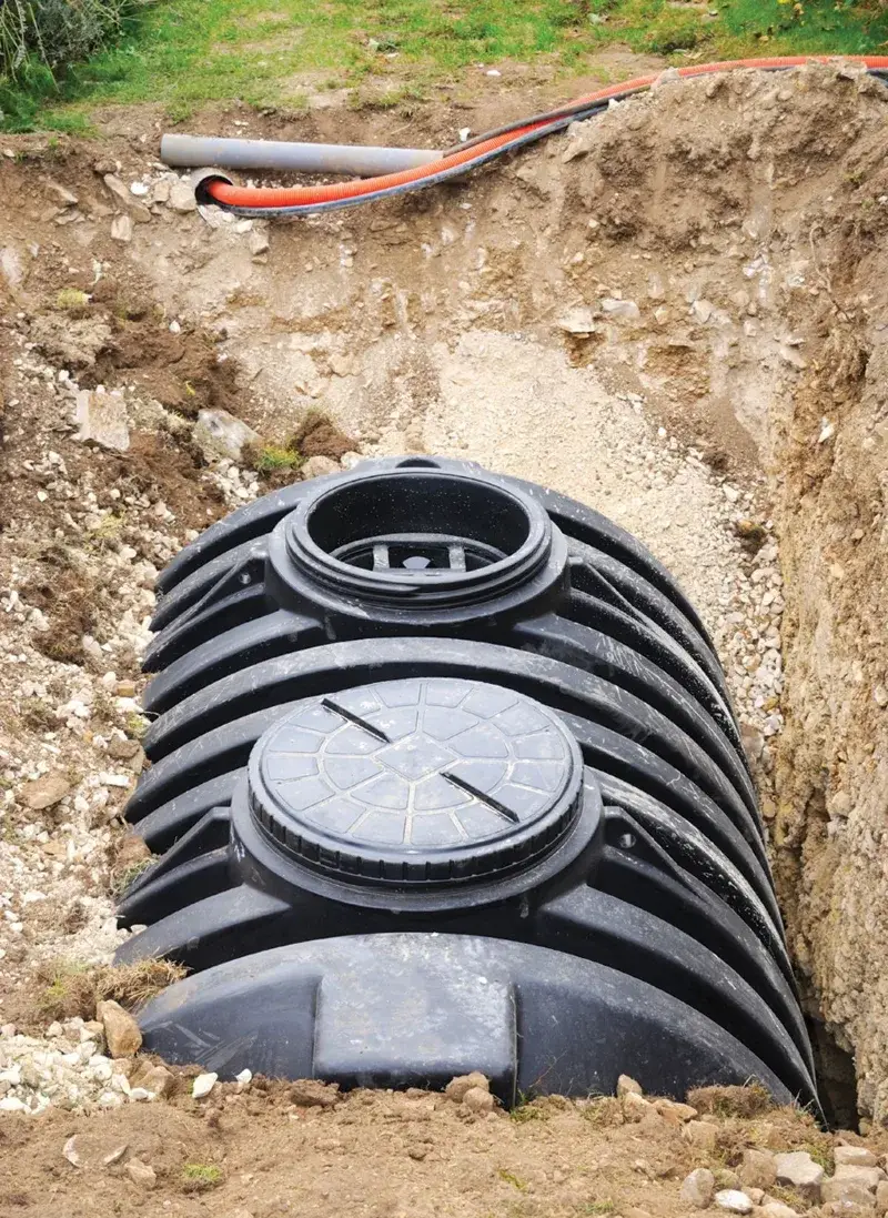 Drain field gravel and distribution box set before backfilling